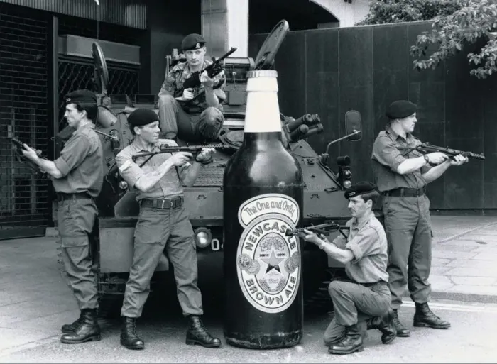 Framed Print : British troops guarding a 6 foot tall bottle of Newcastle brown ale standing in front of