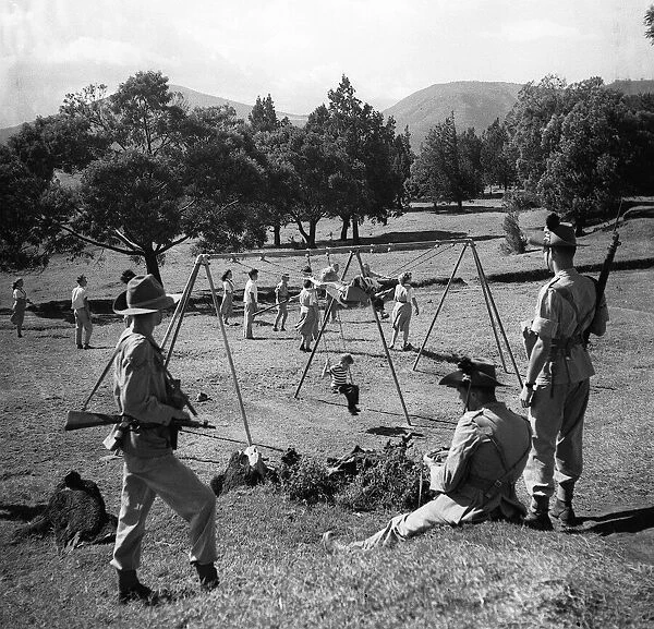 British troops guarding children from the threat of Mau-Mau terrorists 1952