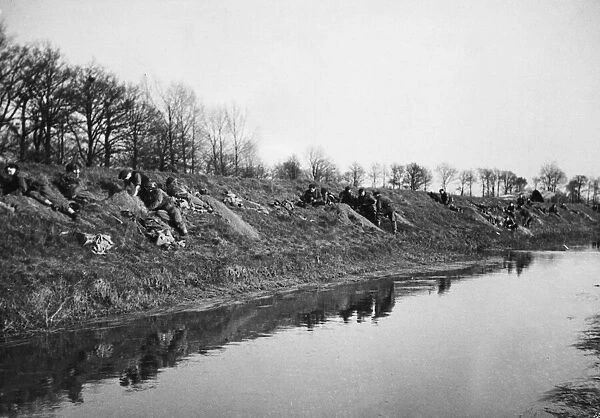 British troops land east of the Rhine. British glider troops digging in
