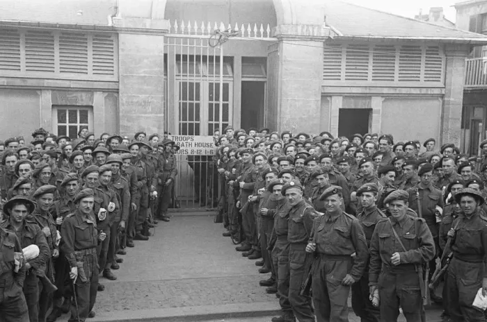 Framed Print : British troops outside the bath house in an unknown Normandy town in Northern France a Framed Print : British troops outside the bath house in an unknown Normandy town in Northern France a