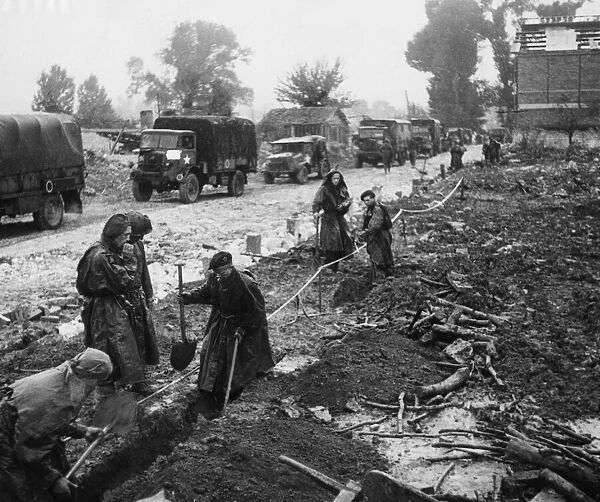 British Troops Push Beyond Seine. Pioneers working on radio drainage in the pouring