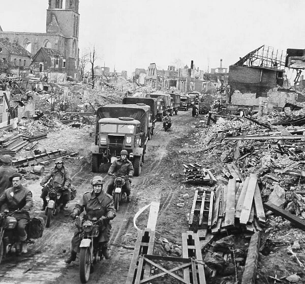 British troops and transport moving through the cleared streets of Stadtlohn, Germany