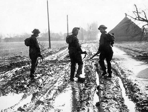 British troops walking up to the front line through deep mud and over heavy ground