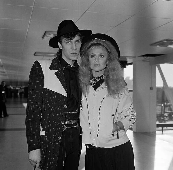 Britt Ekland with boyfriend Slim Jim McDonnell at Heathrow Airport. 16th November 1982