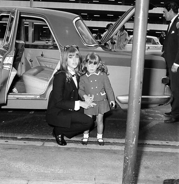 Britt Ekland at London Airport with her daughter Victoria Sellers. 19th September 1967
