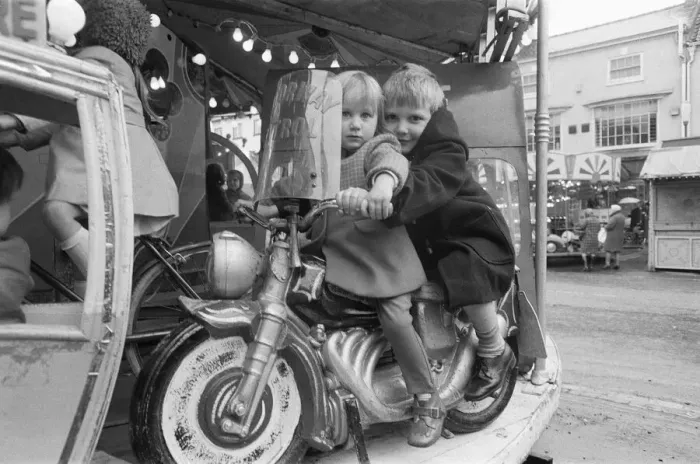 Framed Print : Brother and sister riding a motorcycle on a childs roundabout at the Northallerton Framed Print : Brother and sister riding a motorcycle on a childs roundabout at the Northallerton