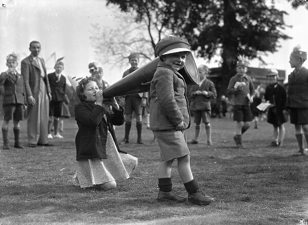 Brother and sister seen here playing with a giant megaphone at the Twickenham Garden Fete