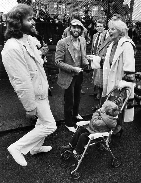 Brothers Barry and Maurice Gibbn of the Bee Gees pop group meet up with neighbours they