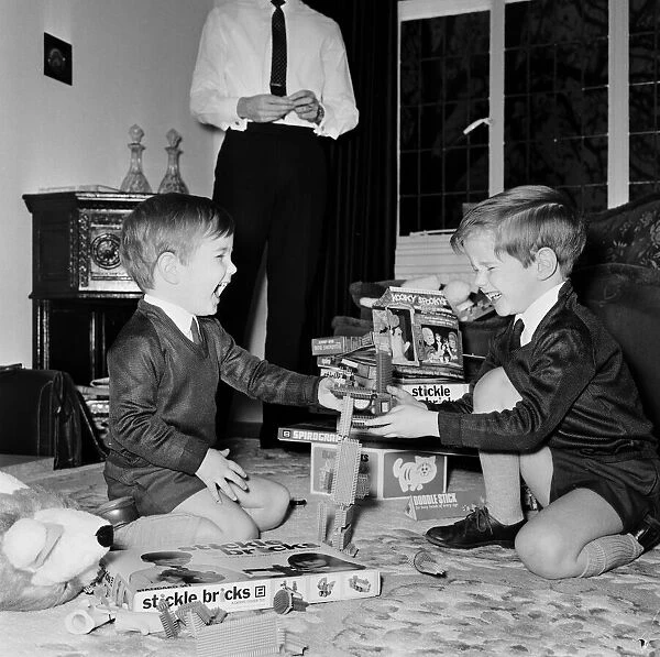 Brothers Martin and Timothy Fieldhouse playing stickle bricks in the living room of their