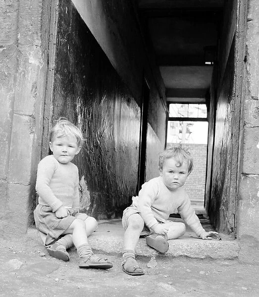 Two brothers seen here playing in a alley way of a tenement block in Govan, Glasgow