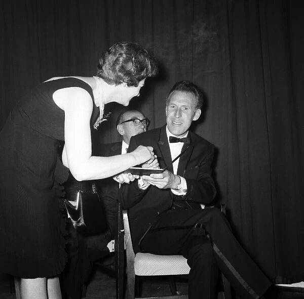 Bruce Forsyth signing an autograph at the Daily Mirror Television Award show