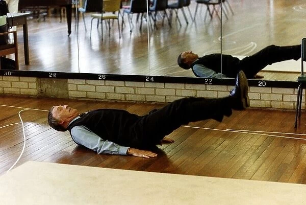Bruce Forsyth TV Presenter and Comedian exercising in Gymnasium