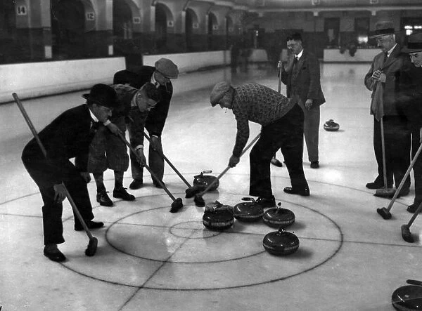 Brushing a stone in during a curling match between Belle Vue