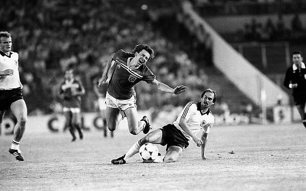 Bryan Robson is fouled by Uli Stielike during England v West Germany during world cup