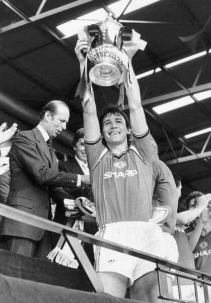 Bryan Robson Manchester Uniteds captain shows off the FA cup to the Wembley crowd after