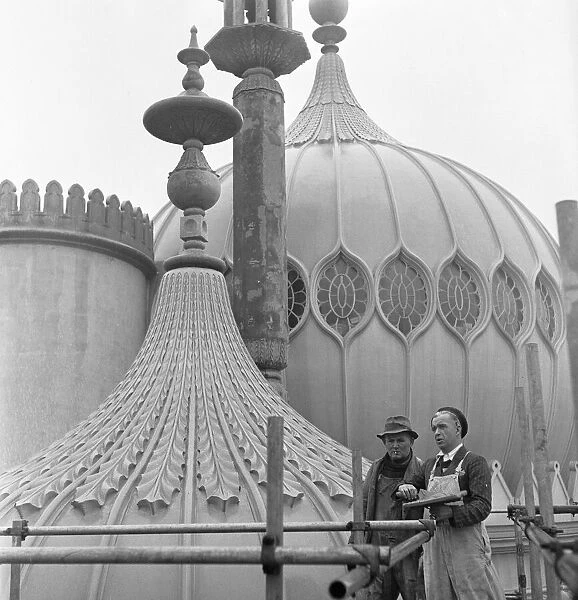 Builders who are involved in the restoration of Brighton Pavilion seen here on the roof