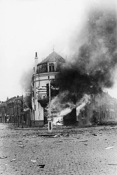 A building blazes in Armentieres after German bombing. 8th June 1940