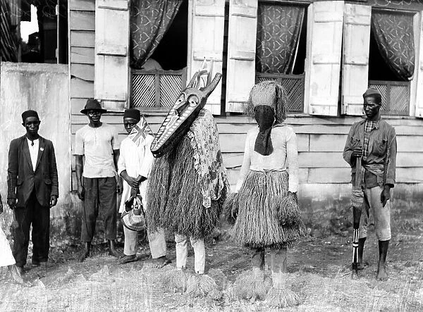 Bundu 'devil dancers'of Freetown in Sierra Leone, dressed in wooden masks