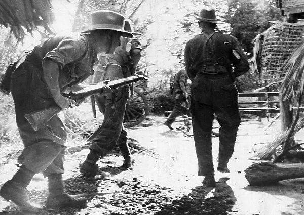 Burma, British Infantrymen search village huts on the approach to Meiktila, Burma