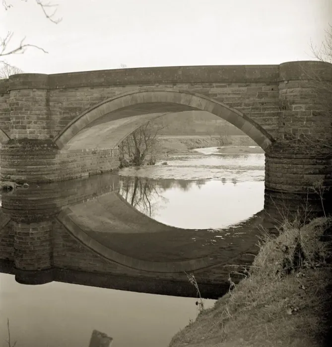 Framed Print : The Burn is tranquil as it passes underneathe the bridge in the fading sunlight not far Framed Print : The Burn is tranquil as it passes underneathe the bridge in the fading sunlight not far