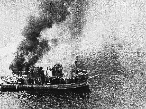 This burning tug is the result of of an attack by R. A. F. Liberators in the Gulf of Siam