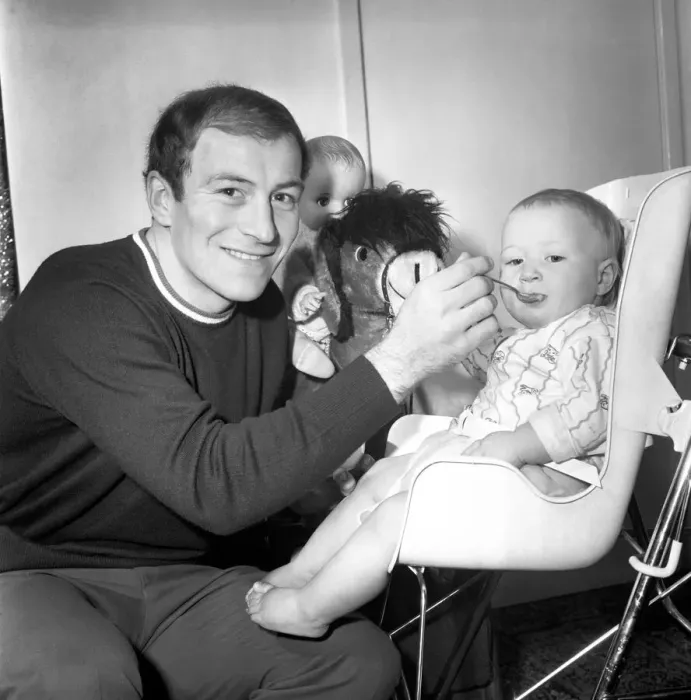 Framed Print : Burnley football player Ralph Coates feeds his new baby girl Lisa. December 1969
