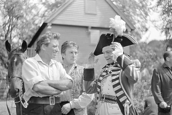Burt Lancaster laughing with his actor colleagues during the filming of The Devils