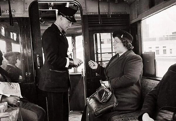 Bus Conductor collecting fares for passengers - circa 1948