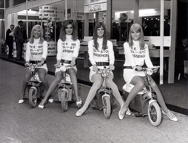 Business Efficiency Exhibition. Four mini-skirted messenger girls sit on their Electric