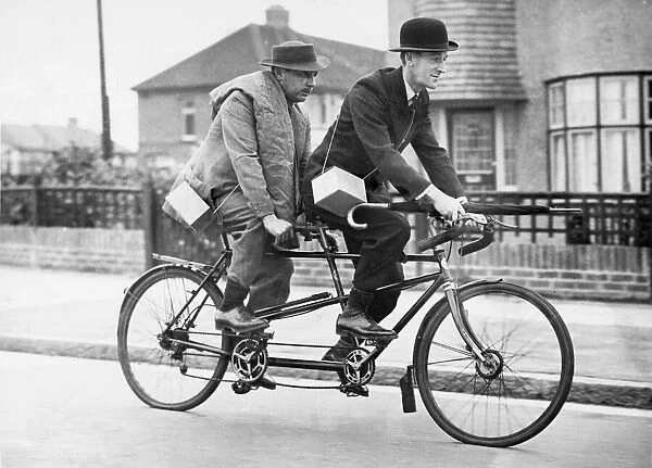 Two business men who usually travel to town by car share a tandem cycle after