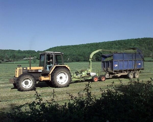 Busy in the fields near Alcester a tractor cutting its crop in the sunshine. 1998