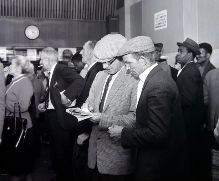 Framed Print : A busy scene inside a betting shop with punters queuing to make bets minutes before Framed Print : A busy scene inside a betting shop with punters queuing to make bets minutes before