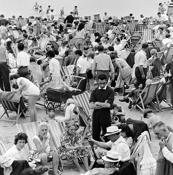 A busy scene on the seafront at Margate, Kent with holidaymakers packing the beach during