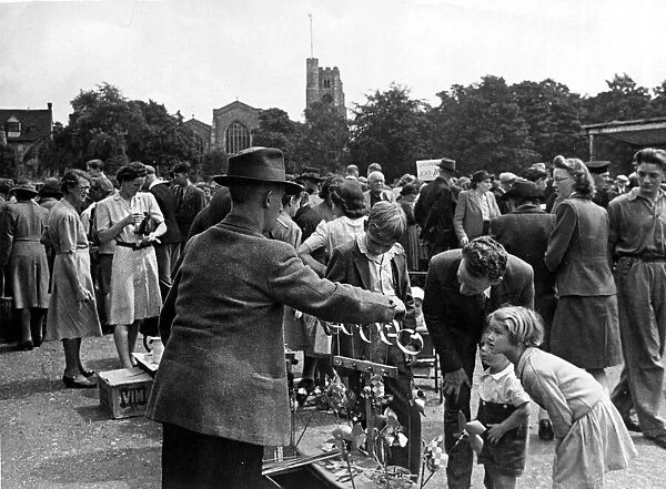 Busy scenes at a local market in Maidstone, Kent. A father with his children looking at