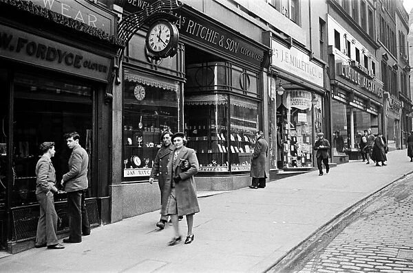 A busy shopping street in Edinburgh, showing the clockmakers James Ritchie & Son who