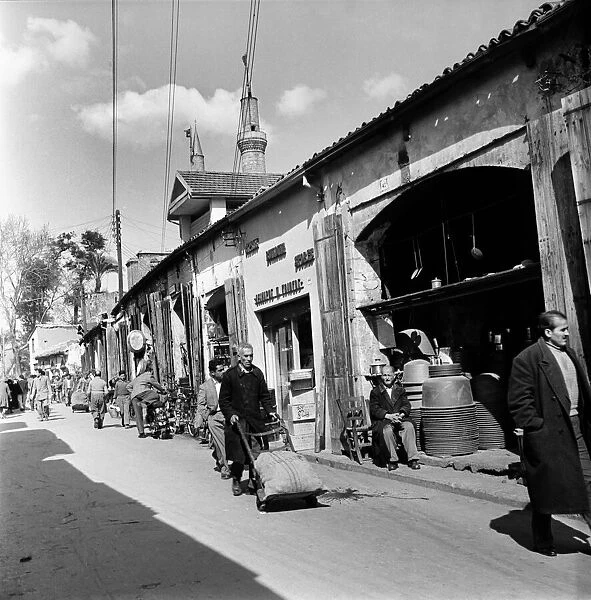 Busy street scene with local transporting their goods in a Cyprus town