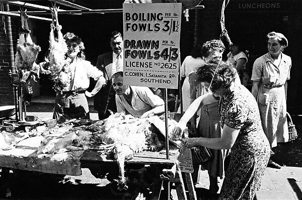 A butchers stall at a market in Whitechapel, East London. Circa 1947