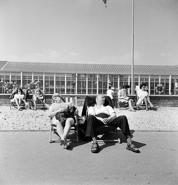 Butlins Holiday Camp at Bognor a couple sleeping in a deckchair with their dog
