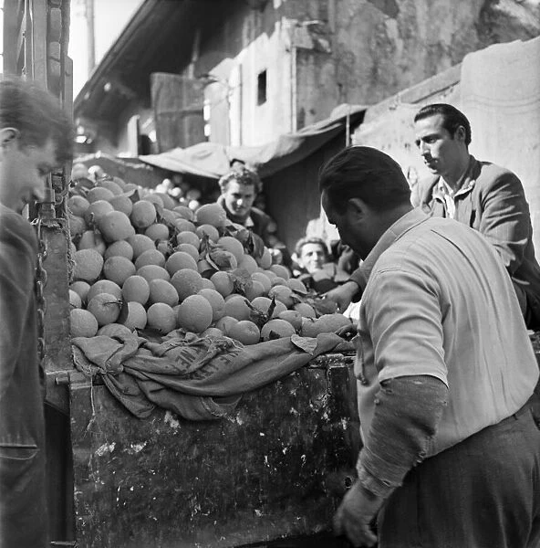 Buying fruit at the local market in a town in Cyprus. March 1952 C1297