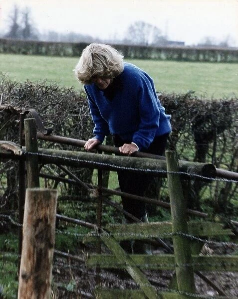 Camilla Parker Bowles leaning over a wooden fence November 1992
