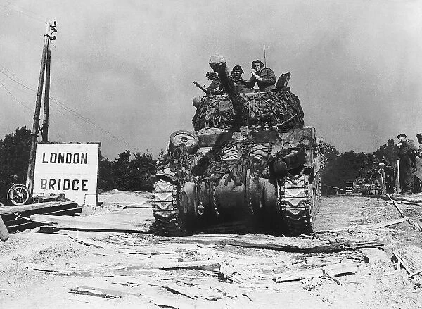 A camouflaged Sherman Firefly tank of the 7th Armoured Division seen here moving up to