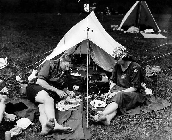Campers enjoying a meal whilst listening to a wireless radio set. June 1924 P000021