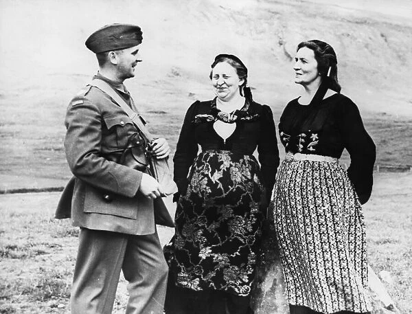 A Canadian officer chats with two Icelandic women in their native costume during Second
