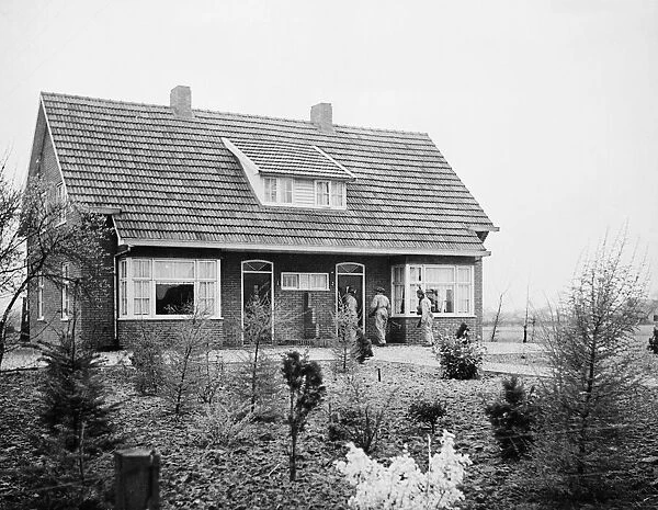Canadian troops searching a house in Holland. 10th April 1945