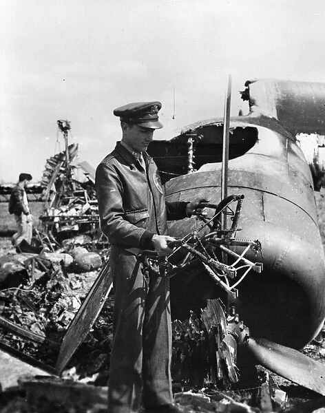 Captain Alvin D. Skaggs of Lawton, Oklahoma, ponders his luck as he holds charred remains