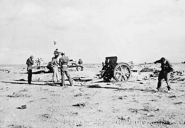 Captured Italian gun being put to good use by British bush artillery men at Tobruk
