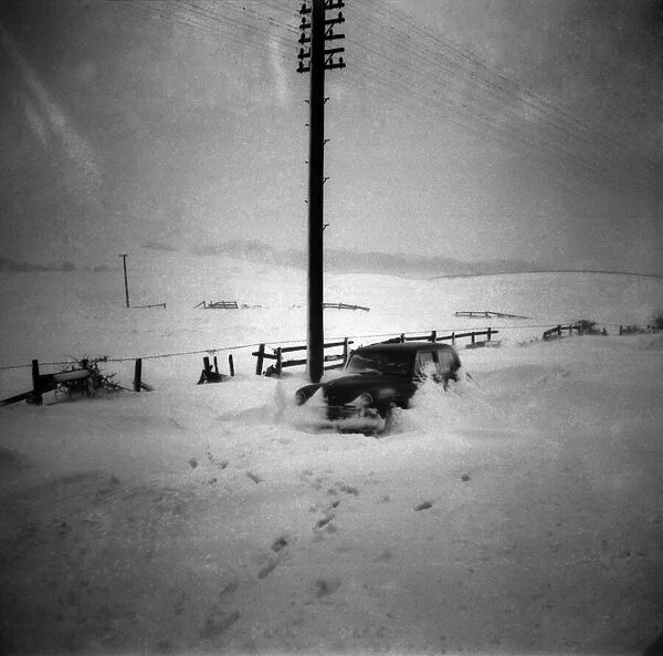 Car abandoned in deep snow after a heavy snowfall. February 1953 D738