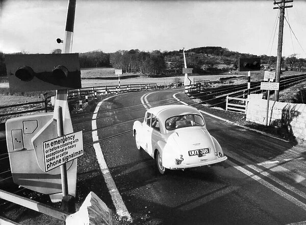 A car crosses over a continental style level crossing. January 1968