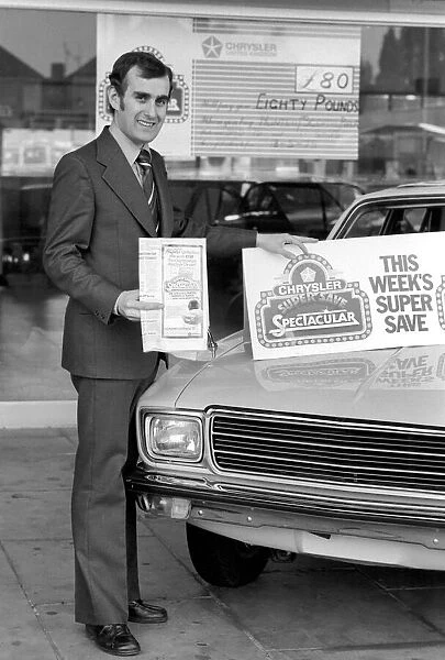 A car dealer putting cars on sale in his garage forecourt. May 1975