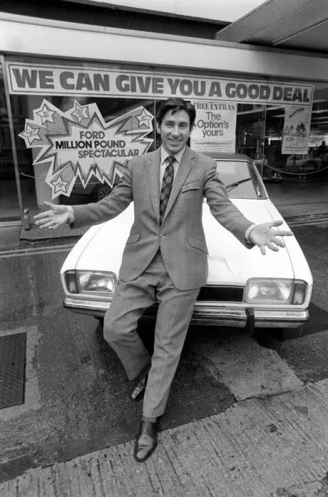 Framed Print : A car dealer putting cars on sale in his garage forecourt in Brighton. May 1975 Framed Print : A car dealer putting cars on sale in his garage forecourt in Brighton. May 1975
